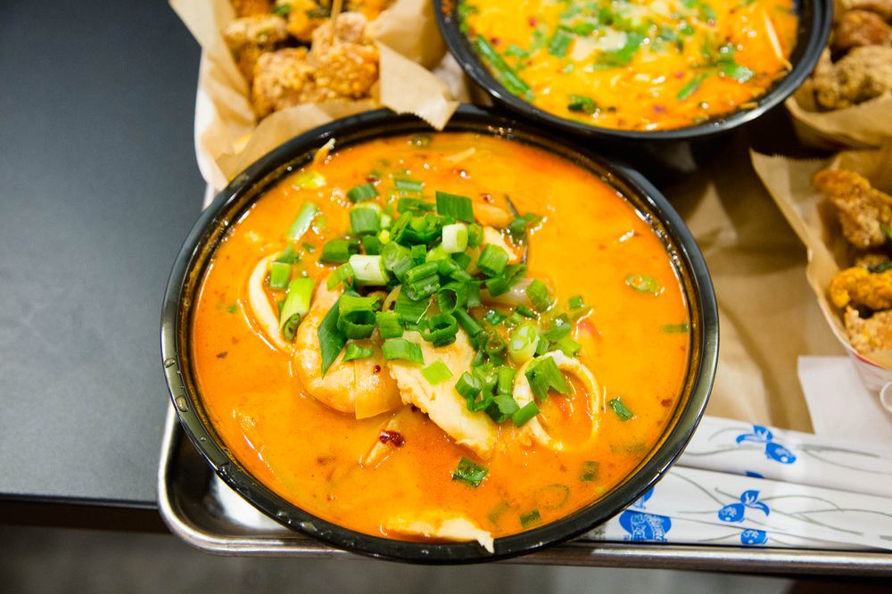 Curry noodle soup with green onion, served with popcorn chicken