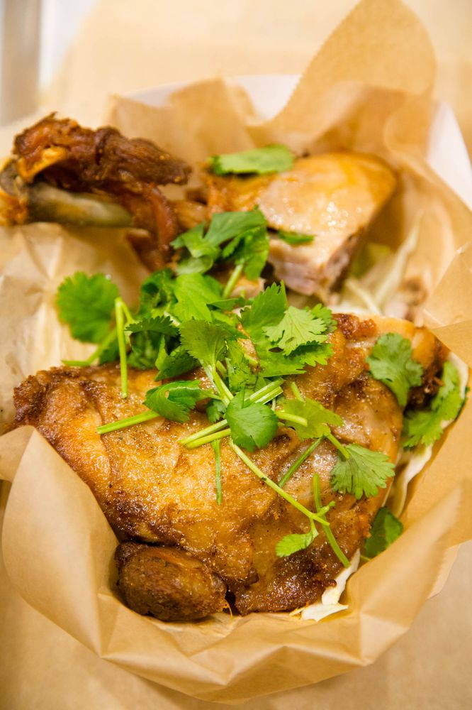Crispy fried chicken leg with cilantro