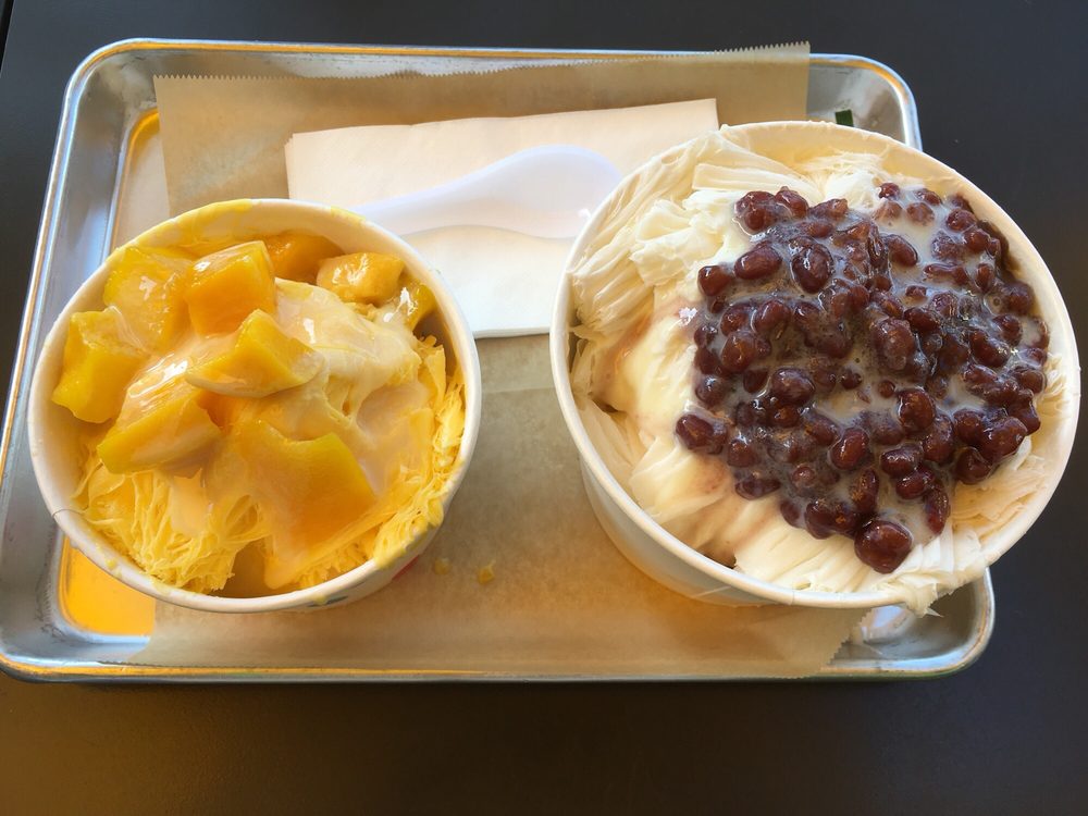 Two cups of shaved snow, one with mango and one with red bean