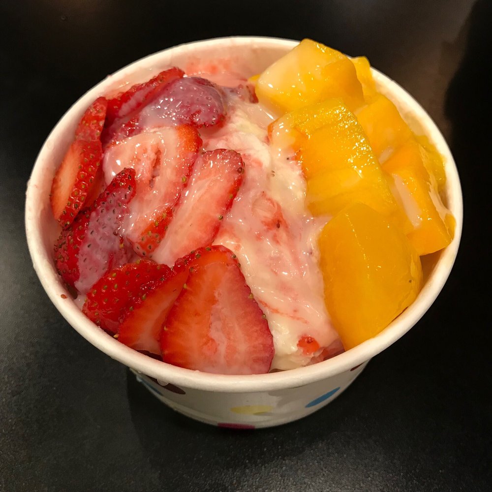 Shaved snow topped with fresh strawberries and mango